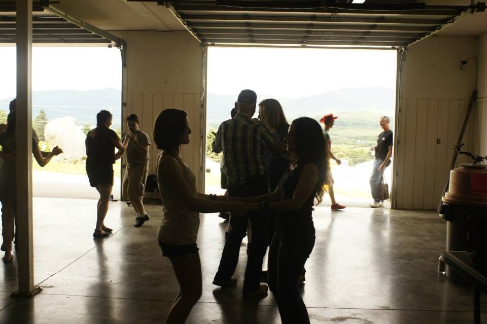 A social dance with the door open onto the hills